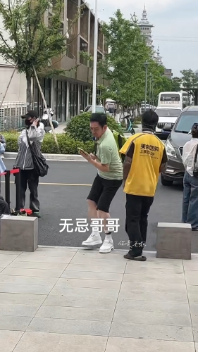 吴启华于内地街头出行，灵巧避过外卖仔。